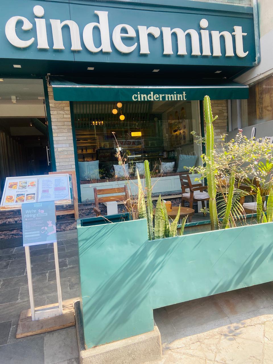 CinderMint storefront on Lakeside Road — chunky white wordmark on a deep teal awning, cacti out front.